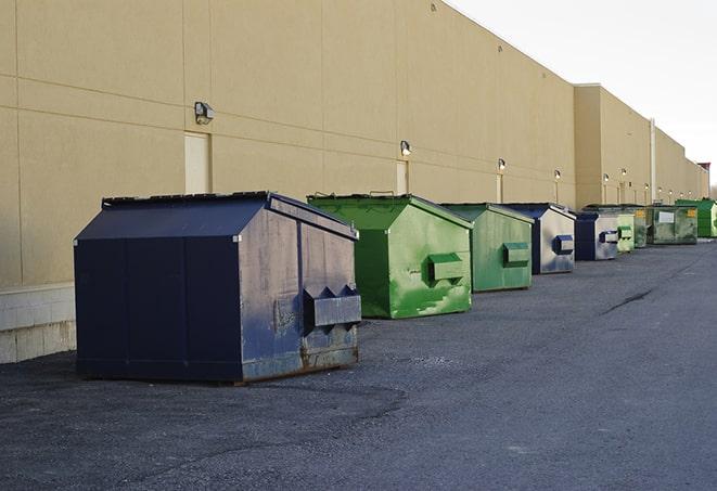 a red construction dumpster placed in front of a building under construction in Garden City, ID